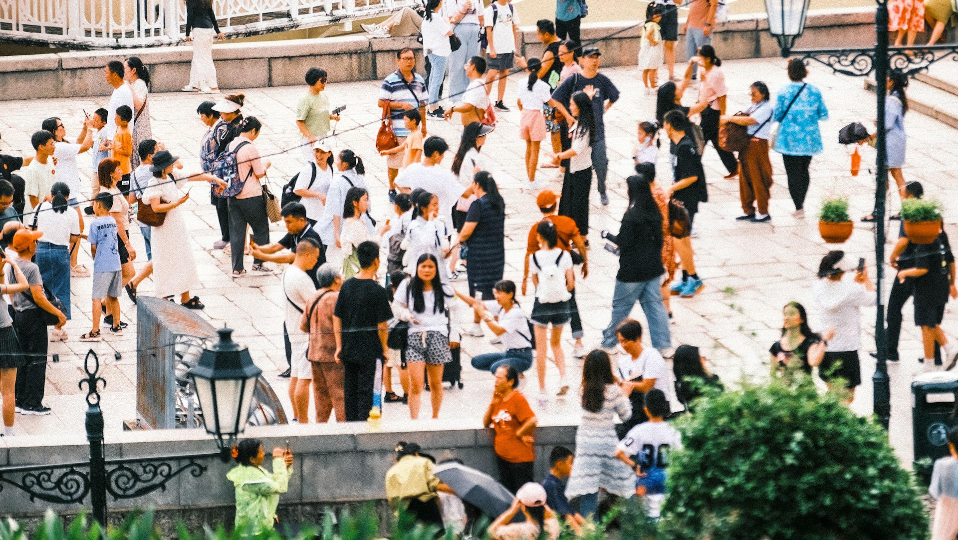 A large group of people standing around a fountain